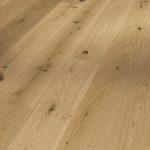Suelo de madera natural Parador Trendtime 4 Roble Lugana acabado mate, parquet de roble 1 lama con veta marcada, nudos visibles y estilo rústico natural para interiores elegantes y acogedores.